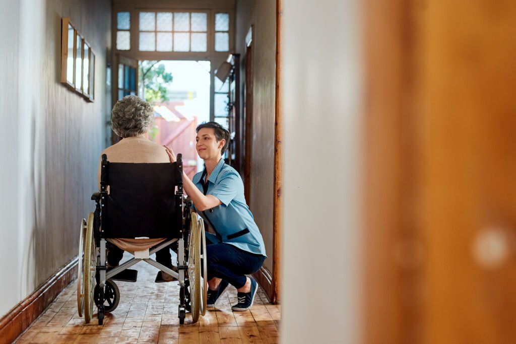 Shot of a nurse caring for a senior patient in a retirement home